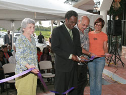 THA Chief Secretary Orville London cuts ribbon to signal the opening of the Shirvan Road Plaza on Friday (December 16th 2011), while (at left) Sameeha Azar, Plaza Owner -Jeffrey Azar and his wife Nancy assist him. Photo courtesy THA Info Dep't.