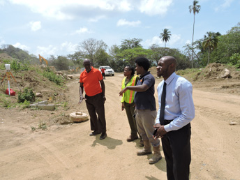 Secretary for the Division of Settlements and Labour Deon Isaac (right) and Administrator Cherryl-Ann Solomon (second from left) during a site visit on Friday (20 March 2015). During the tour the new Administrator was apprised of the status of housing developments that will be delivered in fiscal 2015-16. The housing developments are at Adventure Phase II, Belle Gardens Phase II and Courland.