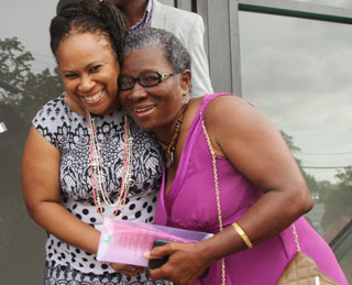 Secretary of Community Development and Culture Councillor Dr Denise Tsoiafatt-Angus (left) and villager Vida Romeo hug each other at the opening of the Bethesda Multipurpose Facility on Sunday. Photos courtesy THA.