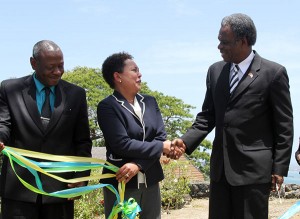  THA Chief Secretary Orville London shakes the hand of US Embassy Chargé d' Affaires Margaret B. Diop at the commissioning ceremony while THA Acting Chief Administrator Paul Thomas looks on.