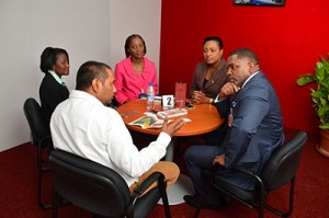 Secretary of Finance & Enterprise Development, Mr Joel Jack discusses growth and development opportunities for Tobago's businesses with TTMA President, Dr. Rolph Balgobin. At the back: From left to right: Lisa Beckles, Business Development Unit’s (BDU's) Strategic Business Development Manager (ag) -Tricia Beckles and BDU's Enterprise Assistance Fund Manager- Shelly Ann Baptiste.