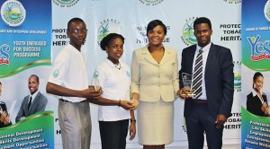 Outstanding Leadership Awardees: From left to right: Agents of Change-Arthur Goddard and Lloyen Scotland, Assistant Programme Director of the Youth Energised for Success Programme, Ms Shamfa Cudjoe and Dexter Wilson Jr. from the Summer Internship Programme. Absent from the photo is Kofi Daniel, who was also an award recipient.