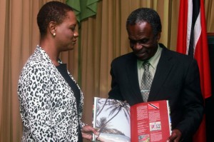 Chief Secretary Orville London and Minister of Tobago Affairs show off the latest edition of Capital of Paradise 11 during the Minister’s courtesy call on Monday. Photos courtesy THA