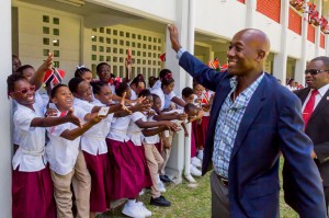 Students at Bishops High School wave in excitement during the the Honourable Dr. Keith Rowley’s visit to their school.