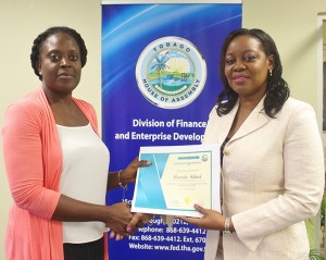 Administrator of the Division of Finance and Enterprise Development, Mrs. Claire Davidson-Williams presenting Ms. Morenike Adekale of the Division of Settlements and Labour with her certificate at the closing ceremony of the Public Private Partnership Workshop which was held the Victor E. Bruce Financial Complex on 24th March, 2016.